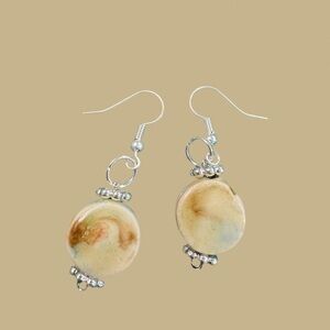 One-of-a-kind hand built ceramic circle earring light brownish.Art you can wear.